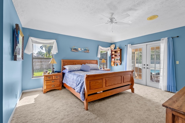 bedroom featuring ceiling fan, light colored carpet, access to outside, and french doors