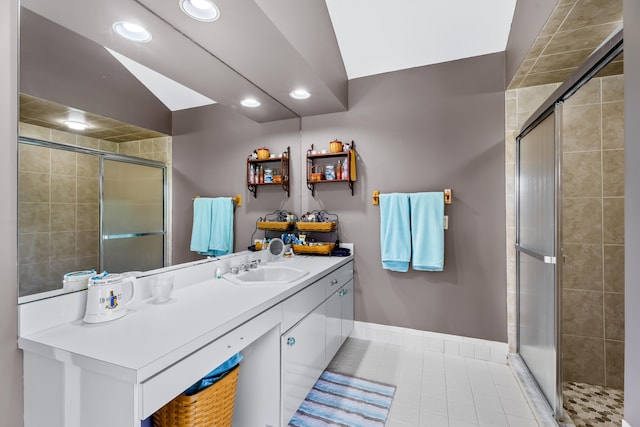 bathroom with tile patterned floors, vanity, and walk in shower