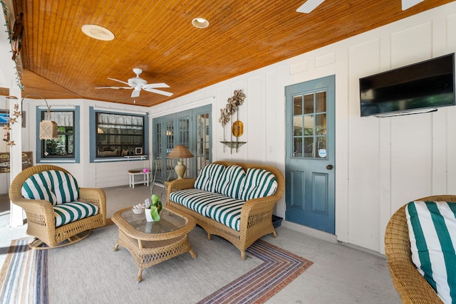 sunroom / solarium with plenty of natural light, ceiling fan, wood ceiling, and vaulted ceiling