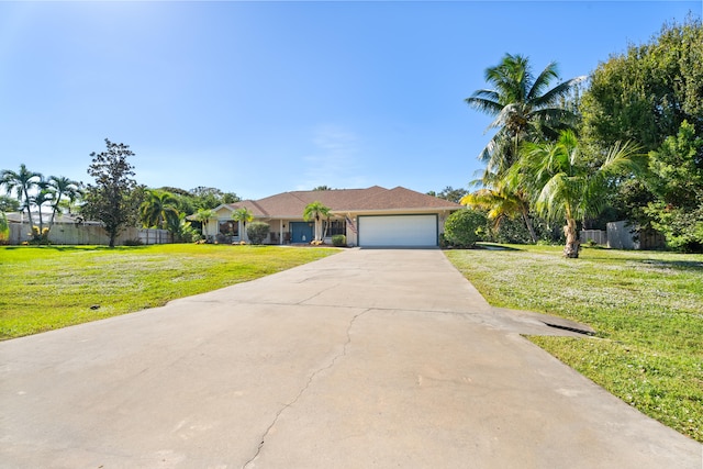 ranch-style house with a garage and a front lawn