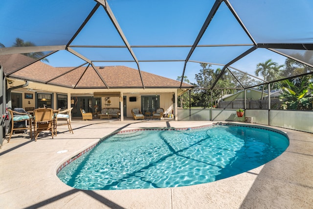 view of swimming pool featuring a patio and a lanai