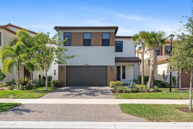 view of front of home with a garage and a front lawn