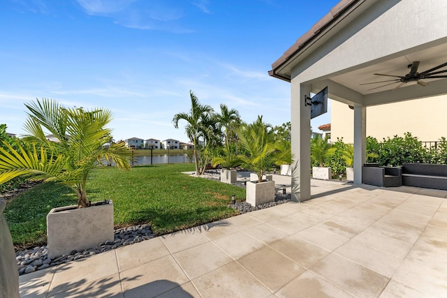 view of patio with a water view and ceiling fan