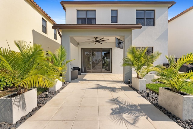 entrance to property featuring ceiling fan