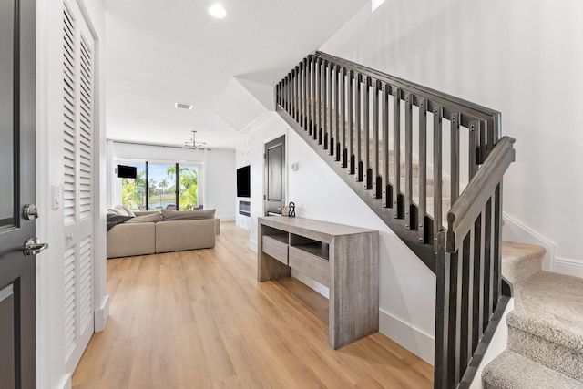 stairs with hardwood / wood-style floors