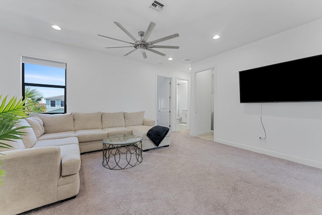 living room featuring ceiling fan and light colored carpet