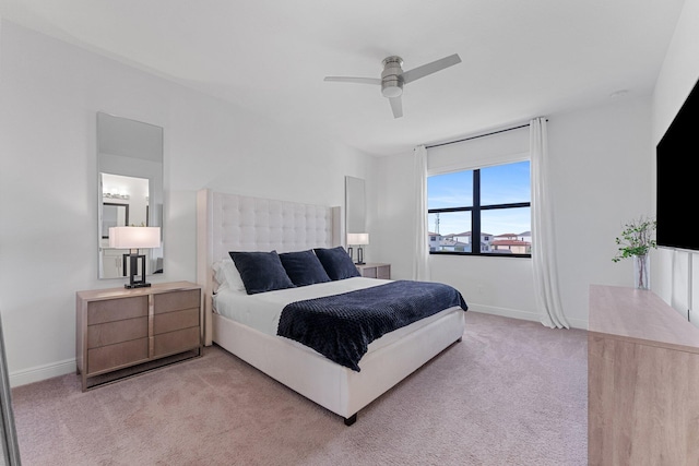 bedroom featuring light colored carpet and ceiling fan