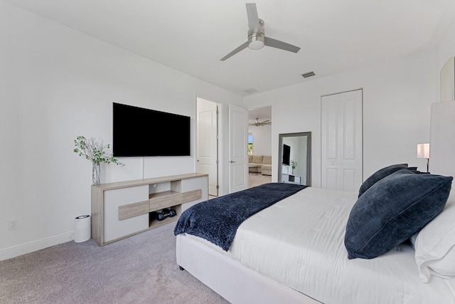 carpeted bedroom with a closet and ceiling fan