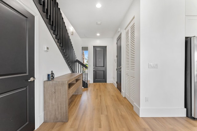 corridor with light wood-type flooring