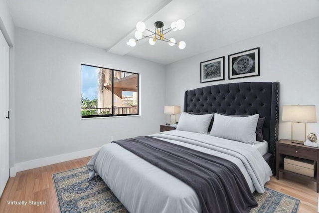 bedroom featuring hardwood / wood-style floors and a chandelier