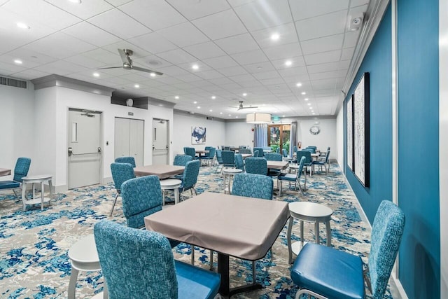 dining space with carpet and ceiling fan