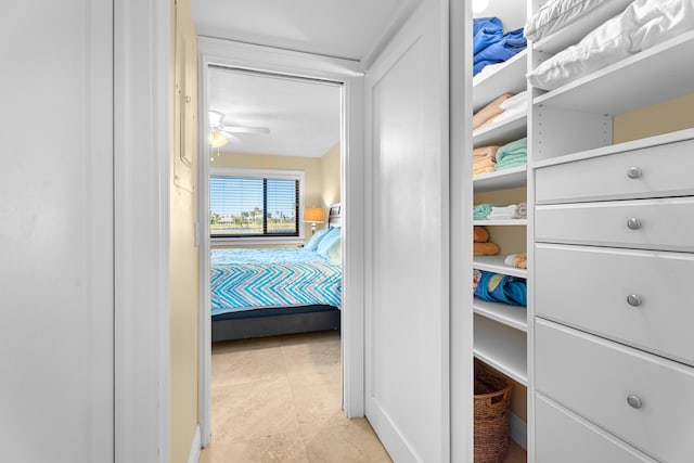 walk in closet with ceiling fan