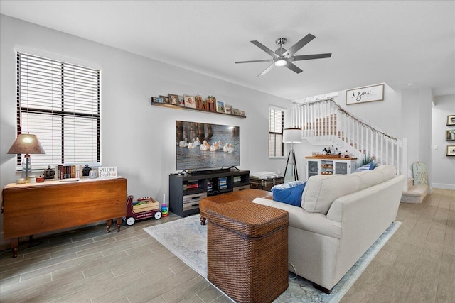 living room with light hardwood / wood-style flooring and ceiling fan