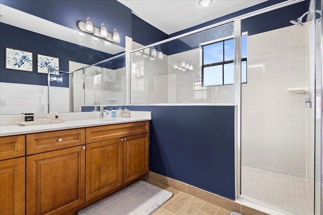 bathroom featuring vanity and an enclosed shower