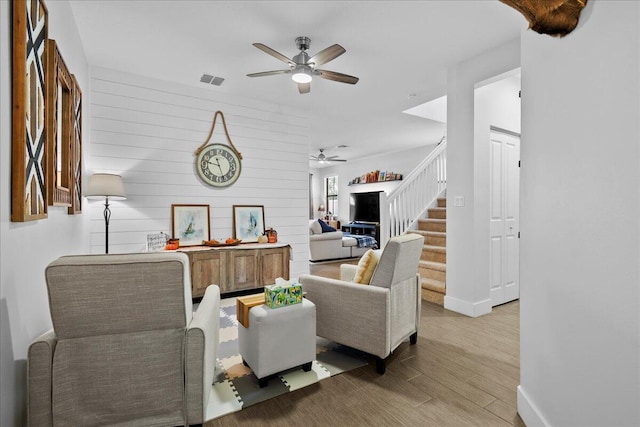 living room featuring hardwood / wood-style flooring and ceiling fan