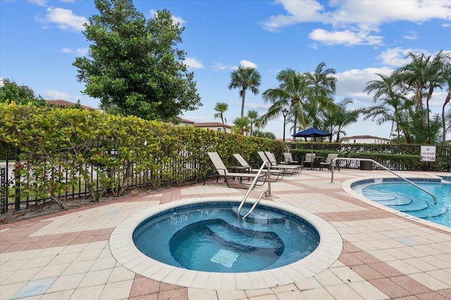 view of pool featuring a community hot tub and a patio