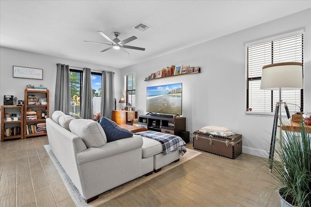 living room featuring ceiling fan and light wood-type flooring