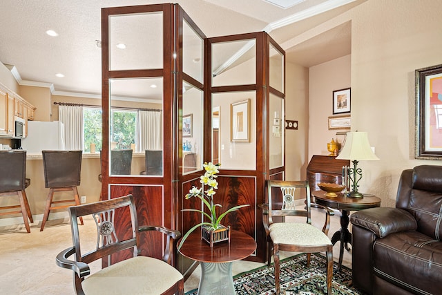 living room with a textured ceiling and crown molding