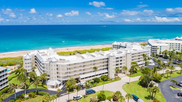 bird's eye view featuring a water view and a beach view