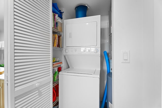 laundry area with stacked washer / dryer