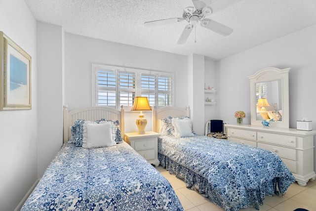 tiled bedroom featuring a textured ceiling and ceiling fan