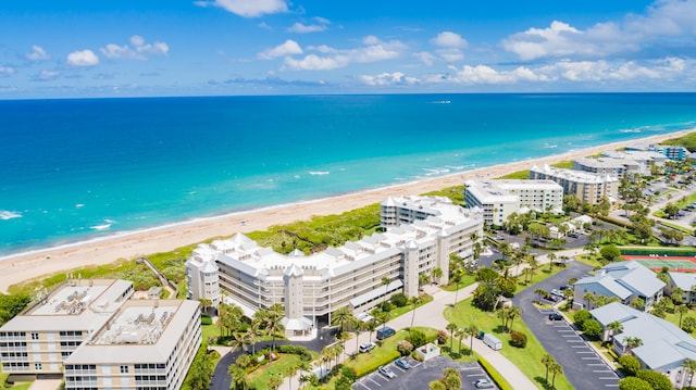 birds eye view of property with a beach view and a water view