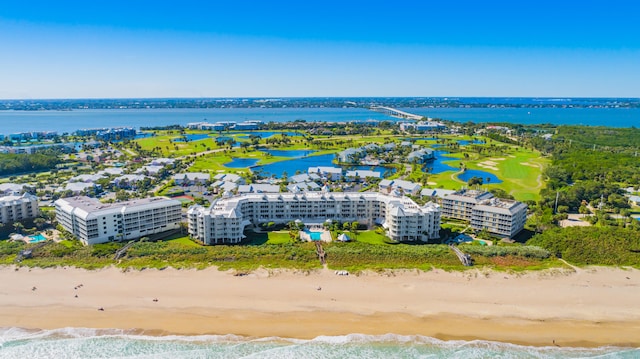 birds eye view of property with a beach view and a water view