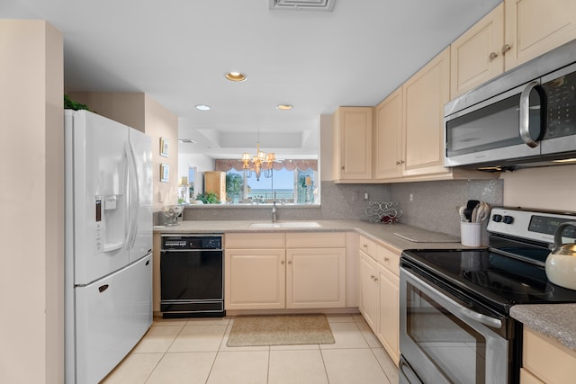 kitchen featuring sink, stainless steel appliances, an inviting chandelier, backsplash, and light tile patterned floors