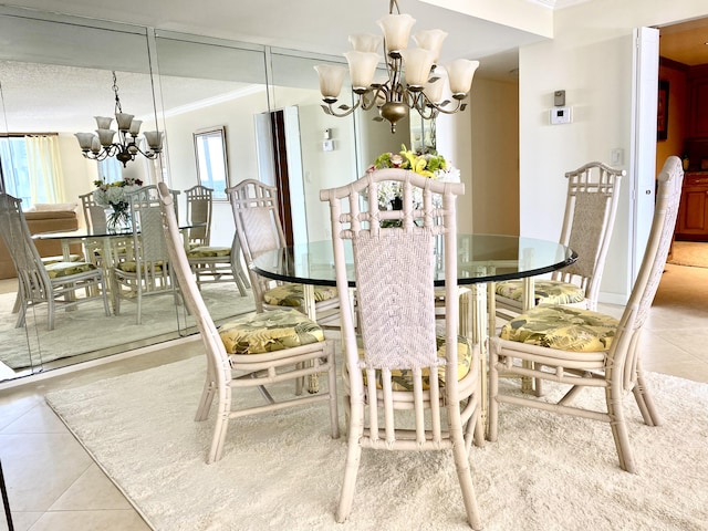 dining room featuring crown molding, light tile patterned flooring, and an inviting chandelier