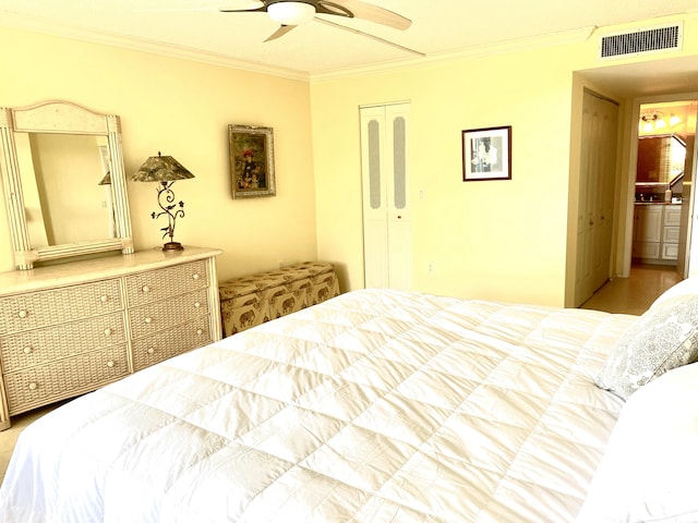 bedroom featuring a closet, ceiling fan, and crown molding