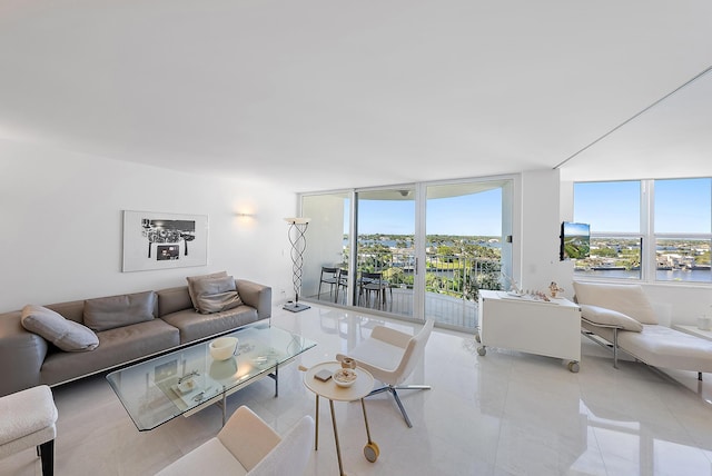 tiled living room featuring a water view