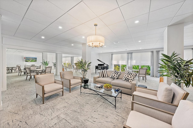 carpeted living room with an inviting chandelier