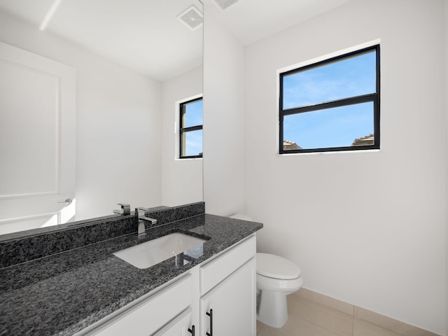 bathroom with tile patterned flooring, vanity, and toilet