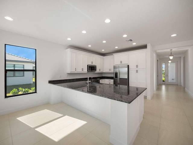 kitchen featuring white cabinetry, a wealth of natural light, sink, and stainless steel appliances