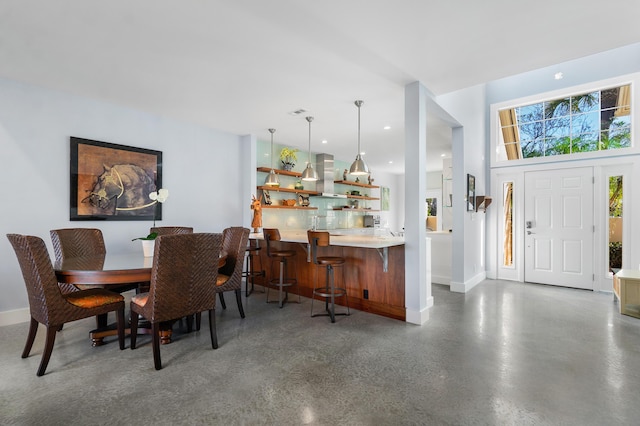 dining room featuring bar area