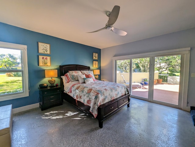 bedroom with concrete flooring, access to outside, and multiple windows