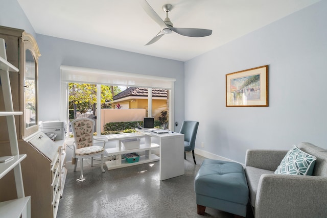 office with ceiling fan and concrete floors