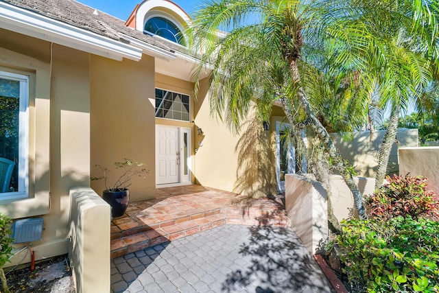 entrance to property featuring heating unit and a patio area