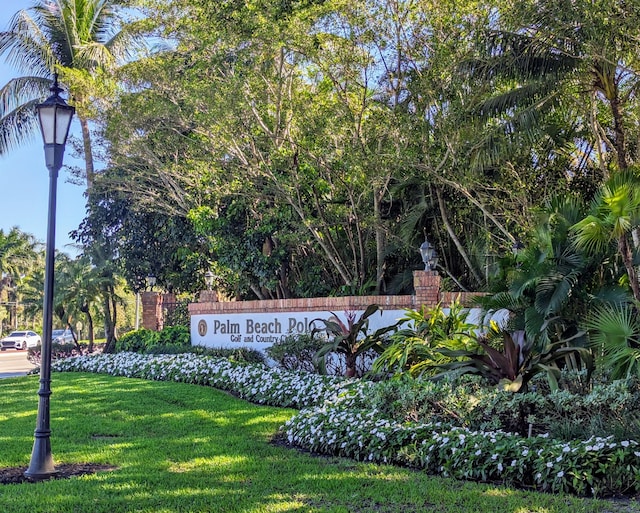 community / neighborhood sign with a lawn