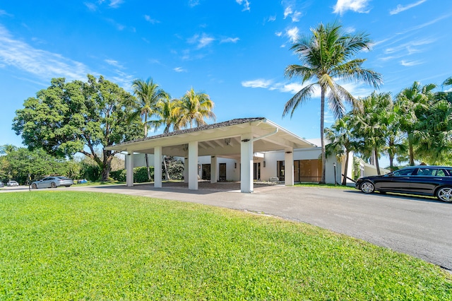 exterior space featuring a carport and a front yard