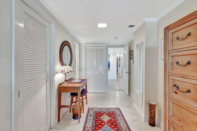 hall with light tile patterned floors and ornamental molding