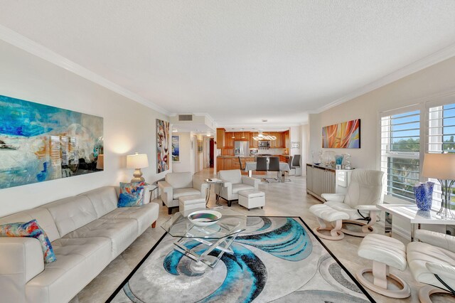 living room featuring ornamental molding and a textured ceiling