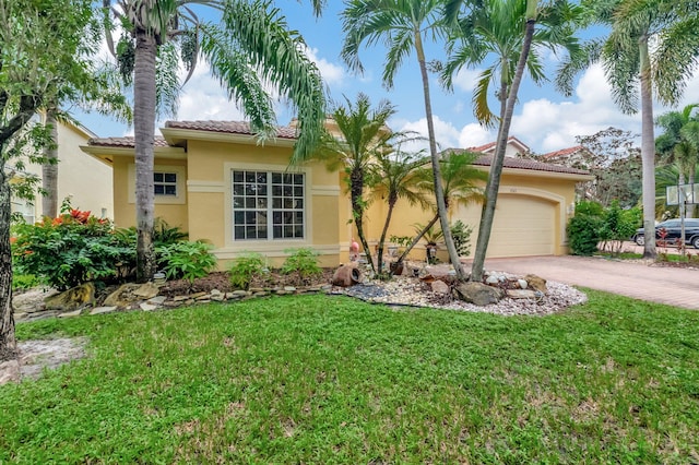 view of front of property featuring a front yard and a garage