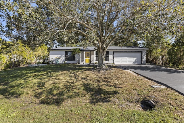 view of front of house featuring an attached garage, driveway, and a front yard