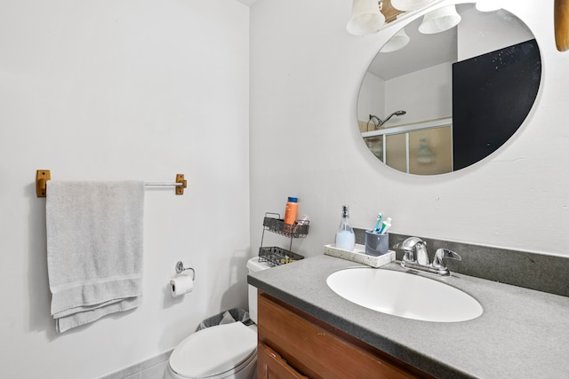 full bath with toilet, an enclosed shower, and vanity