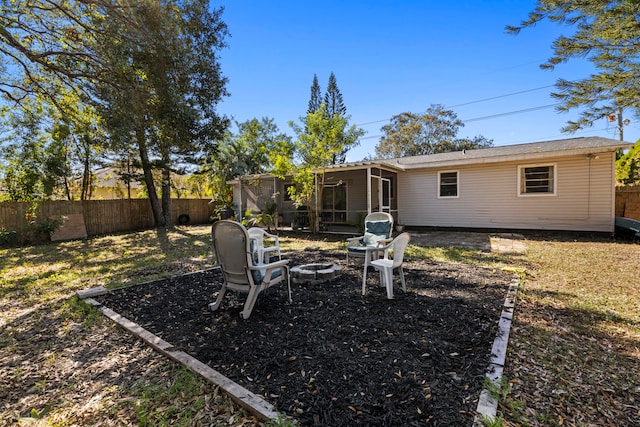 view of yard with a fenced backyard and a fire pit