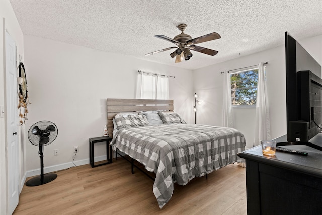 bedroom featuring a textured ceiling and light wood-style floors