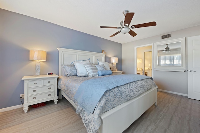 bedroom with ceiling fan and ensuite bath