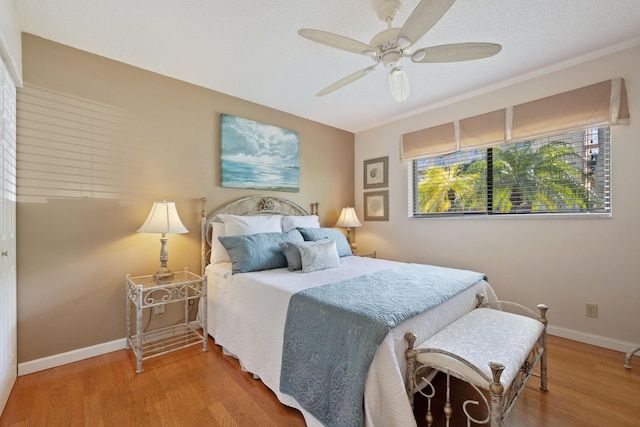 bedroom with ceiling fan and hardwood / wood-style floors