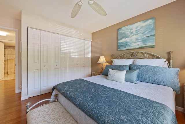 bedroom with hardwood / wood-style flooring, ceiling fan, and a closet